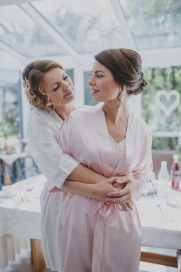 Die Braut mit ihrer Schwester vor ihrer Hochzeit auf dem Weingut in Würzburg fotografiert von Würzburger Hochzeitsfotografin Conny Schöffmann Photography